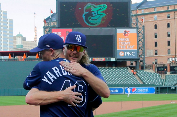 Tampa Bay pitchers Ryan Yarbrough (48) and Ryne Stanek embrace after the Rays beat the Baltimore Orioles 4-1 on Sunday in Baltimore.