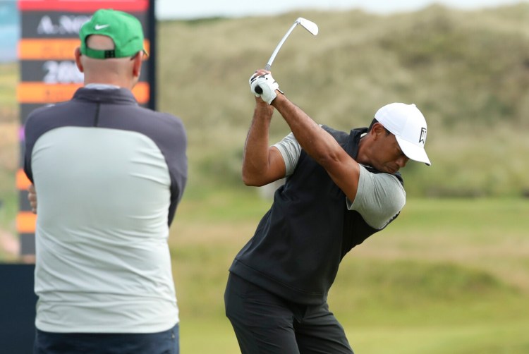 Tiger Woods of the United States hits a shot at the practice ground ahead of the start of the British Open golf championships at Royal Portrush golf course in Northern Ireland, Tuesday, July 16, 2019. The British Open starts Thursday. (AP Photo/Jon Super)
