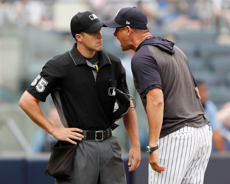 Yankees Manager Aaron Boone, right, gets in the face of home plate umpire Brennan Miller during the second inning of New York's game against Tampa Bay on Thursday. Boone was suspended one game for the outburst. 