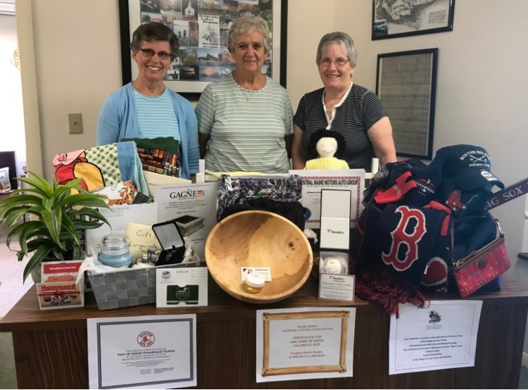 The Friends of the Belgrade Public Library will host its Live & Silent Auction Fundraiser starting at 7 p.m. Sunday, Aug. 18, at the Community Center for All Seasons. From left are Judy Johnson, Beverly Megill and Joan MacKenzie standing in front of some of the auction items.