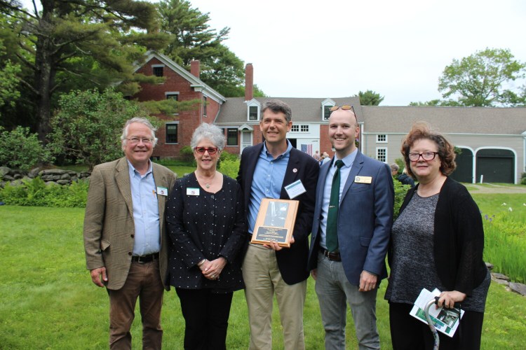 To a standing ovation, Steven Hufnagel, executive director of Coastal Rivers Conservation Trust, accepted the Frances Perkins Center Partners in Place Award on June 26. From left are Michael Chaney, Francis Perkins Center executive director; Sarah Peskin, FPC board chairwoman; Steven Hufnagel; and Scott Wilkinson and Andrea Quaid, regional representatives for US Sen. Angus King. 