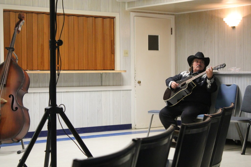 Jeff Simon, one of the state's country music hall of fame inductees, warms up on the guitar before a performance for a live taping of "Maine's Down Home Country Jamboree" Sunday night at the old Waterville Legion building on College Avenue. Simon used to perform on "Dick Stacey's Country Jamboree," which the new show is based off of, in the 1970s and '80s.