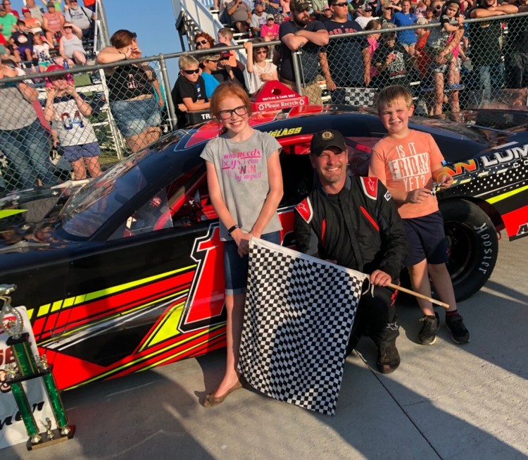 Kevin Douglass of Sidney, center, celebrates his Pro Stock win on Saturday in victory lane at Wiscasset Speedway.