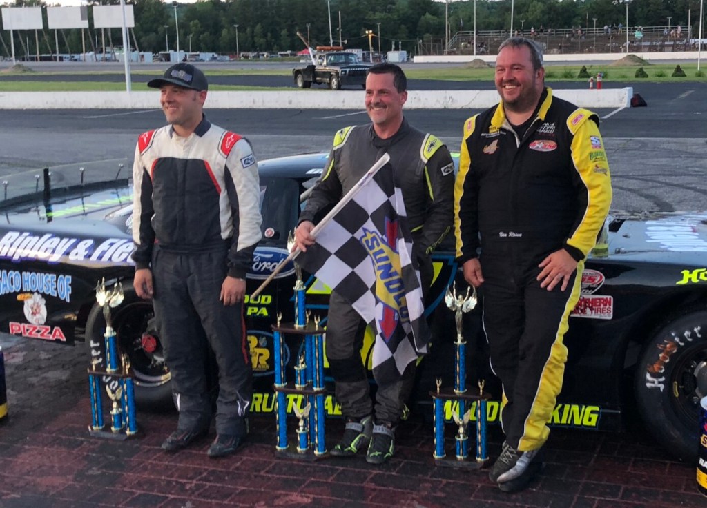 Nick Sweet, left, Curtis Gerry, center, and Ben Rowe stand in victory lane following Gerry's win in the PASS 150 at Oxford Plains Speedway in Oxford in July.