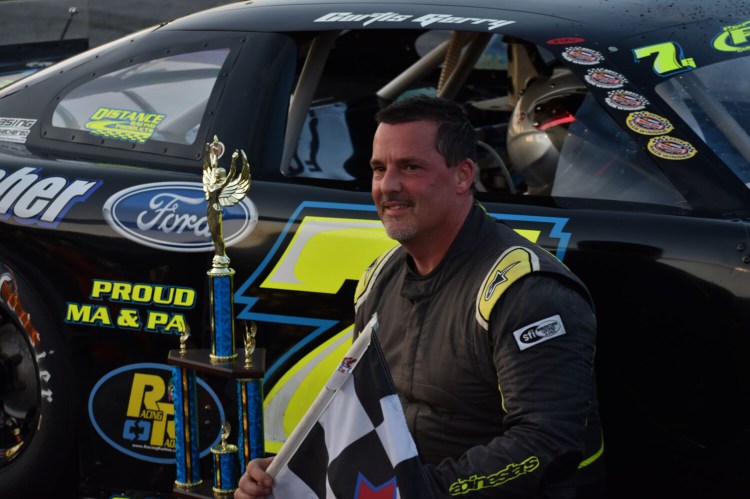 Curtis Gerry celebrates his victory in the PASS 150 race at Oxford Plains Speedway in July.