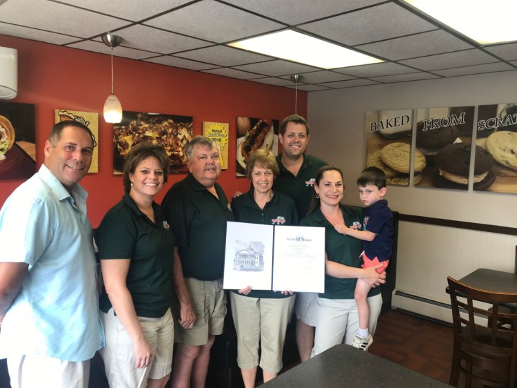 Three generations of the Partridge family pose Saturday with a legislative sentiment from the Maine Senate, recognizing Al's Pizza in Skowhegan for it's 50th anniversary in business. The family has owned the business since 1969, and has been in the current location at 20 Waterville Road since 1987.