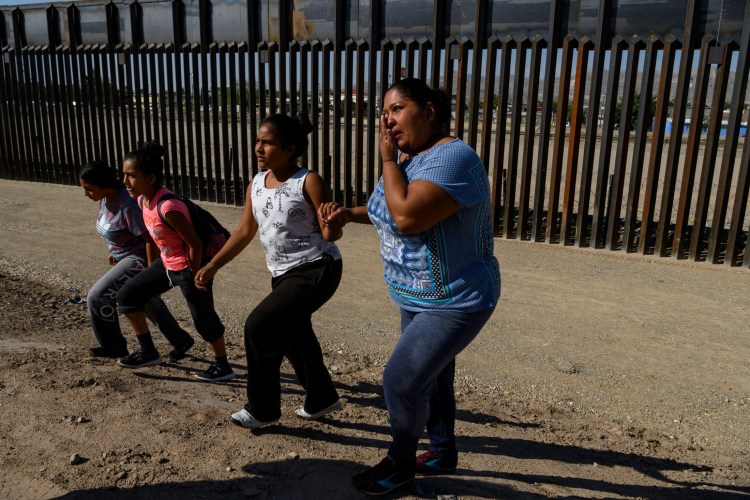 After crossing the Rio Grande from Mexico into the United States, Karla Yadira Rivera, 36, cries as she walks to Border Patrol agents with her daughters Karla, 11, Andrea, 12, and Emilia, 17, in El Paso, Texas, on June 13. 