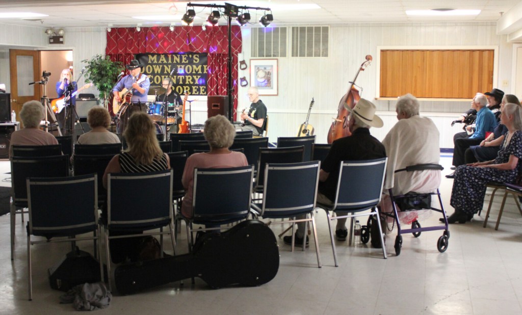 Waterville-area residents listen to host Bob Heller perform traditional country music during a live taping of "Maine's Down Home Country Jamboree" at the old Legion building on College Avenue Sunday night. 