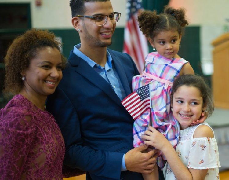 Luis Sanchez of Saco poses with his wife, Raimy Sanchez Constantine, and daughters Sophia Sanchez and Julia Constantine, right, after becoming a U.S. citizen last November.