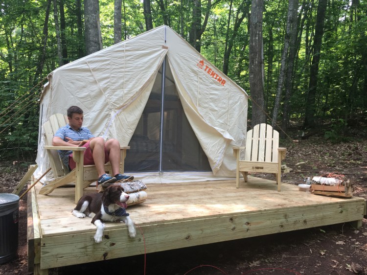 Nick DeBlois and his dog, Brooks, relax at a Tentrr campsite at Camden Hills State Park earlier in July. DeBlois and his wife, Katy, are longtime campers from Brunswick who had never been glamping before.