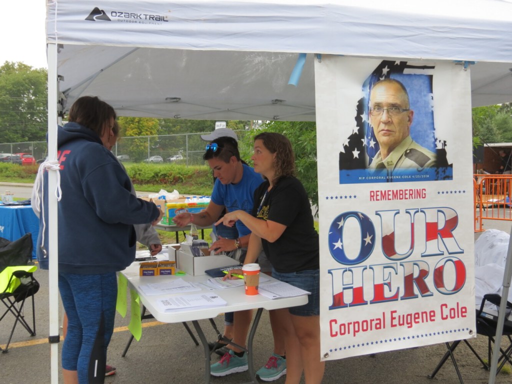 Theresa Howard, a planning committee member for the Corporal Cole Memorial 5K and Half Marathon, registers participants Sunday. 