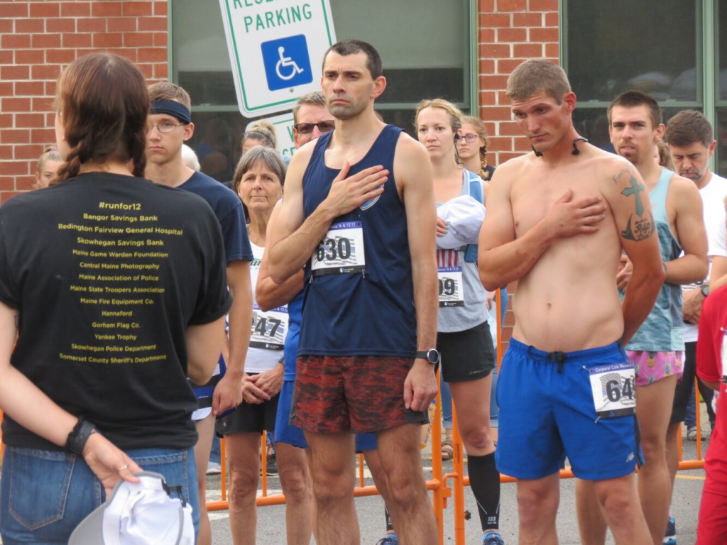 Runners stand for the national anthem prior to Sunday's Corporal Cole Memorial 5K and Half Marathon in Norridgewock. 