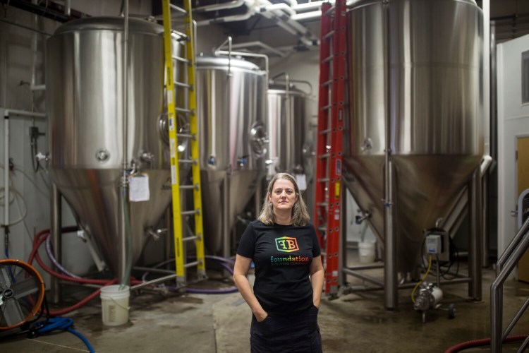 Tina Bonney, one of the founders of Foundation Brewing, poses for a portrait in their brewing space in Portland. The implementation of a new licensing fee for manufacturing alcoholic beverages caught breweries and wineries in Portland by surprise. "I'm disappointed we weren't engaged in the process of creating a new ordinance," Bonney said. 