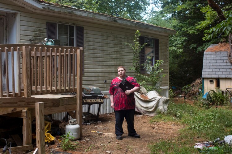 Zachary Beggs, 17, photographed with his school laptop outside his home in New Gloucester, has been a student in Maine Virtual Academy since his freshman year of high school. Beggs, who's now going into his senior year, said he enjoys the online charter school much more than traditional school. 