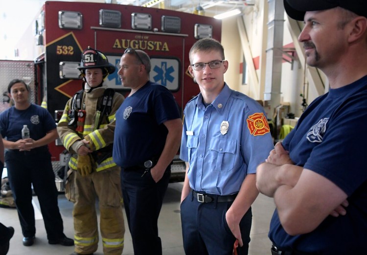 Monmouth Academy senior Logan Farr, second from right, trains Thursday at the Augusta Fire Department. Farr will be enrolling in the Capitol Area Technical Center's firefighting program this school year.