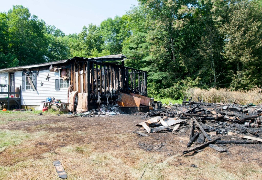 Debris from a barn fire is seen Saturday morning. The Friday blaze destroyed a barn and much of the house at 1266 West Ridge Road in Cornville.