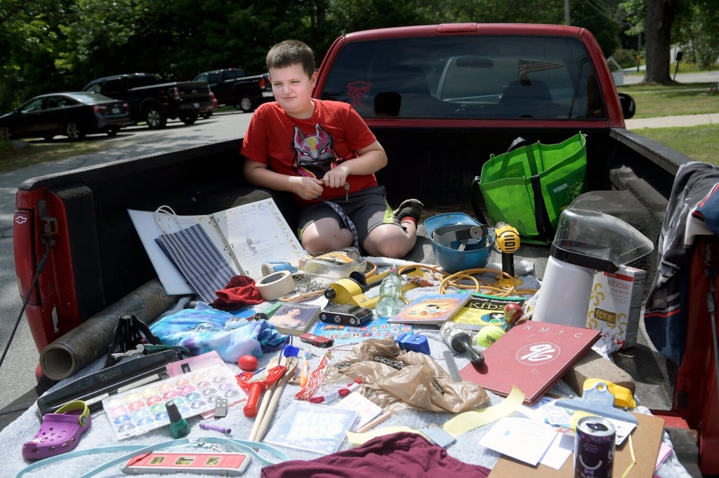 Casper Hooper, 9, waits for a judge to check the collection of items he and his family gathered in the bed of their truck Sunday during the 16th annual China Community Days scavenger hunt.