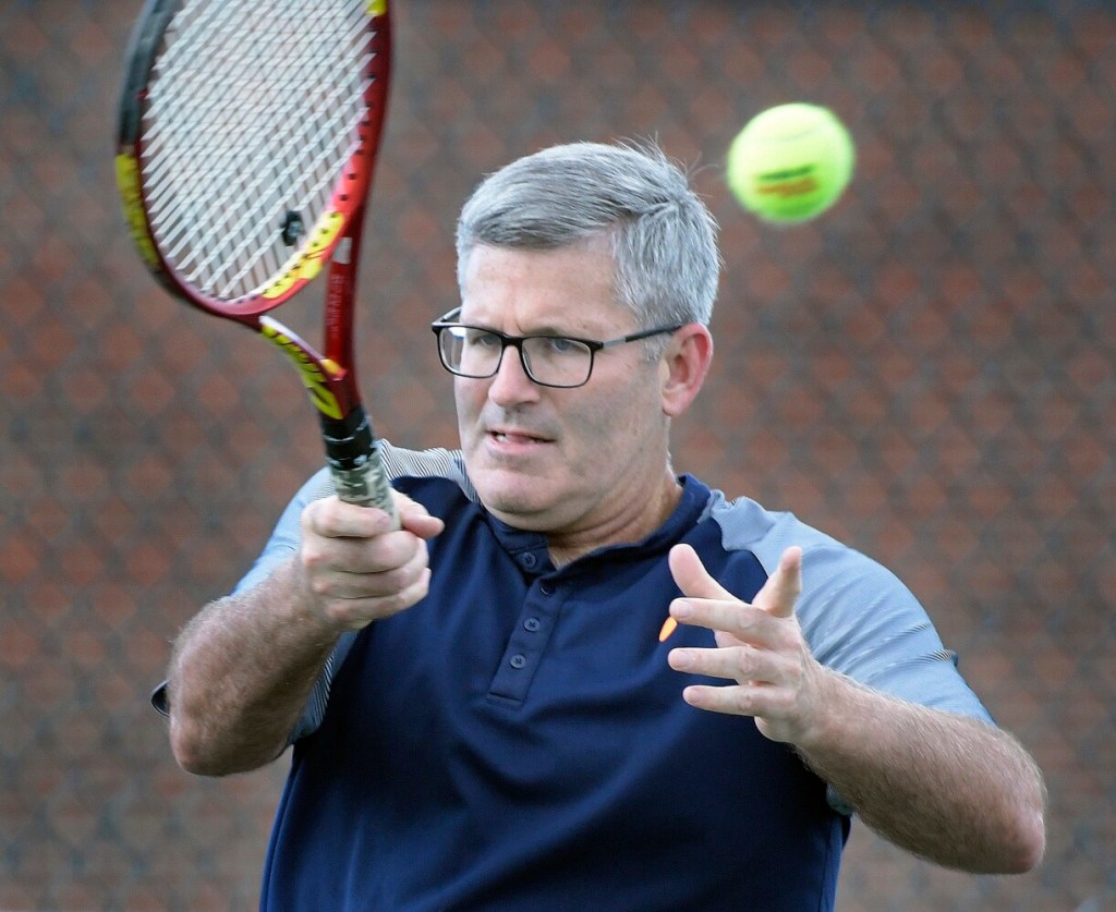Mark Gelsinger plays tennis on Tuesday with his partner, Ken Wells, near their home in Gardiner. 