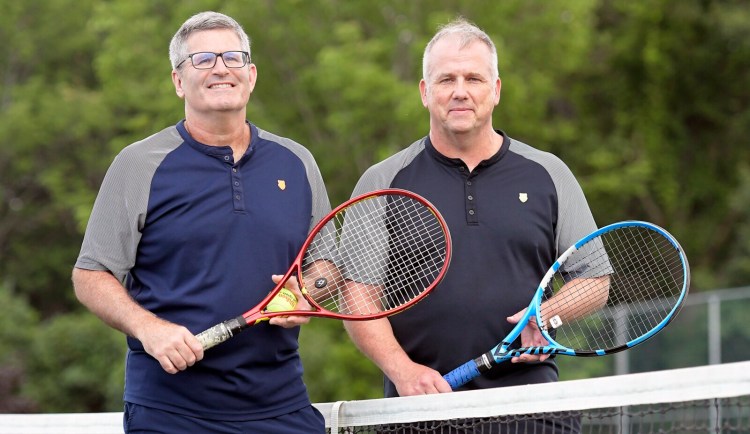 Mark Gelsinger, left, and Ken Wells stand at a tennis net near their home in Gardiner on Tuesday. The pair was recognized last month by the United States Tennis Association as the top-ranked doubles team in New England last year in the 45-and-over category.