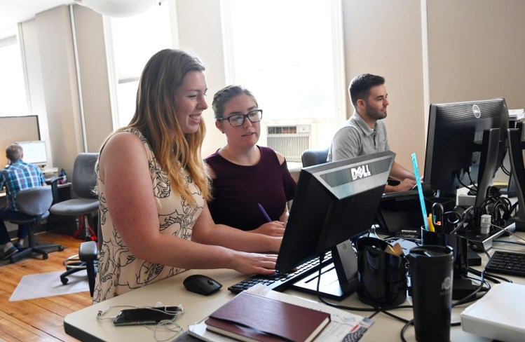 Apprentices Sacha Kiesman, Lauren Whitney and Brian Lee work at WordLab in Portland on Thursday. Almost everyone who completes an apprenticeship goes on to continue working for the sponsoring employer.