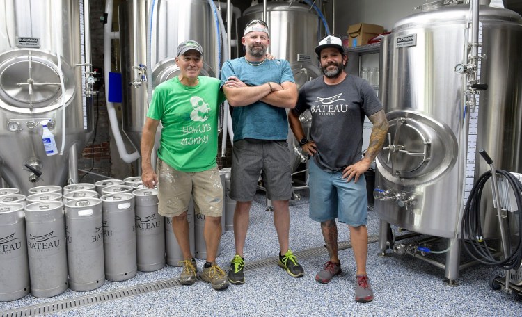 Partners Steve Casey, Jim Swain and Matt Kendall take a break Thursday at Bateau Brewing in Gardiner. The tasting room opened to customers on Saturday.