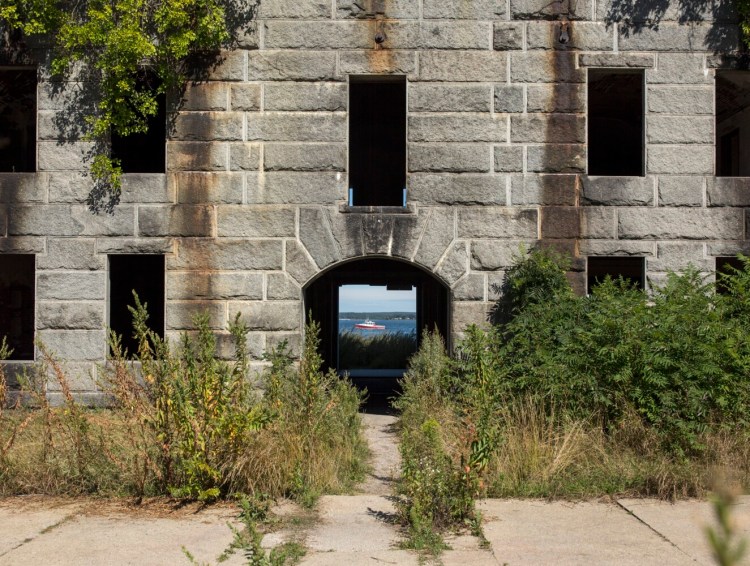 A passing lobster boat appears through the frame of the front gate at Fort Gorges on Aug. 30.