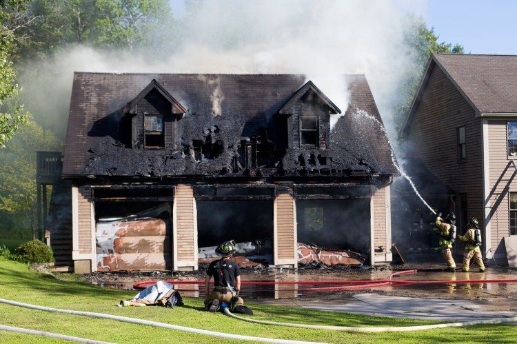 Firefighters from eight departments responded to a fire that started in a garage and spread to an attached house at 8 Foothill Lane in Sanford on Thursday.