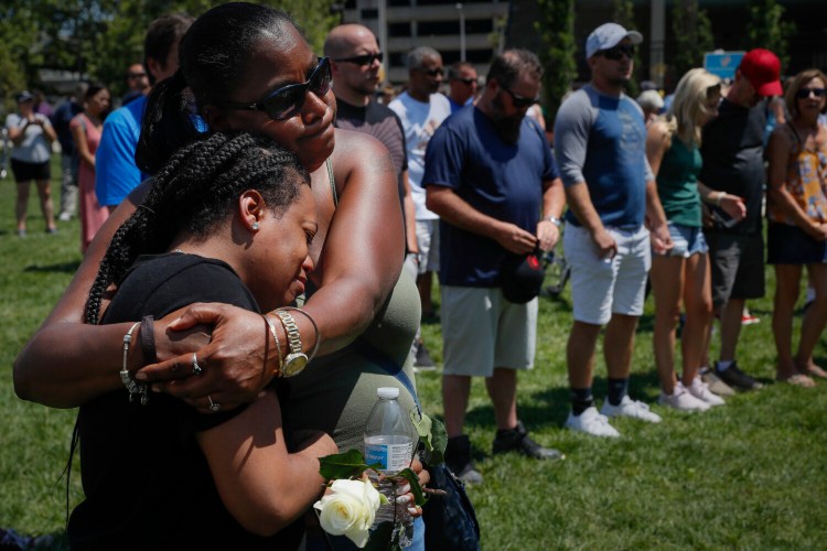 Mourners gather at a vigil after a mass shooting  Sunday in Dayton, Ohio. 

John Minchillo/Associated Press)