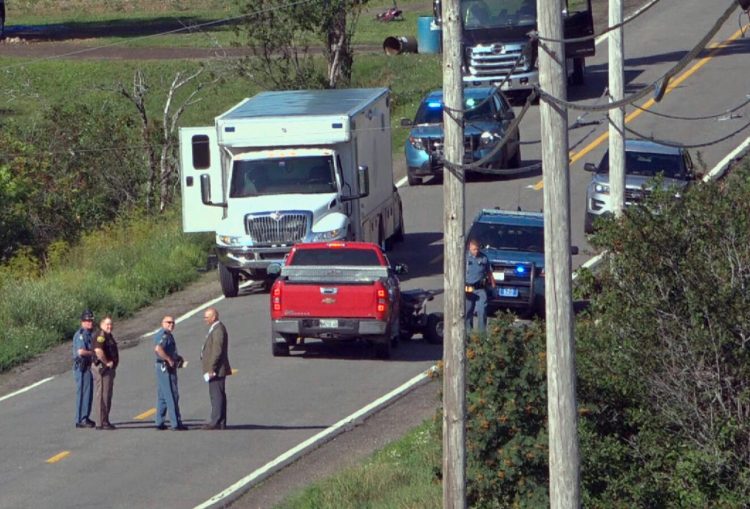 In this image from video provided by WAGM-TV, law enforcement investigators surround a red pickup truck where two people were found shot to death in Castle Hill in August. The victims were identified as Roger Ellis, 51, and Allen Curtis, 25, both of Castle Hill. 