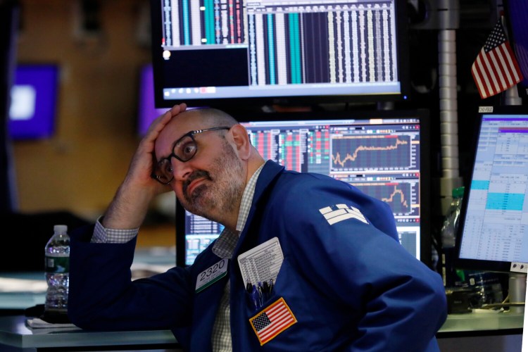 Specialist Peter Giacchi works on the floor of the New York Stock Exchange on Friday, when stocks tumbled after President Trump said he "hereby ordered" U.S. companies to consider alternatives to doing business in China.