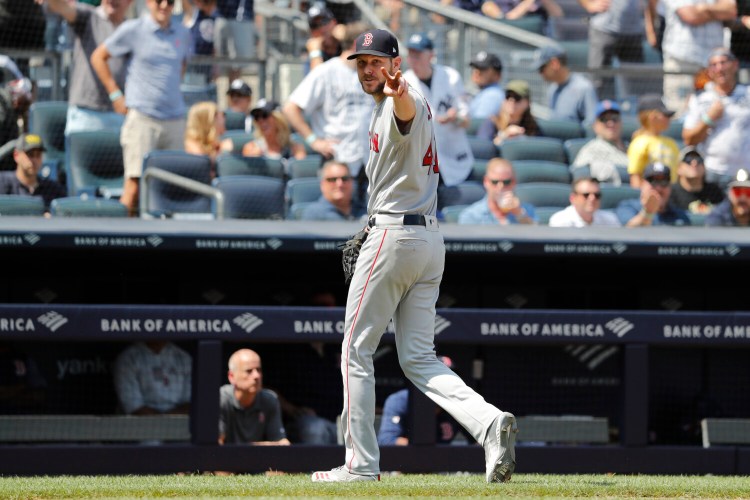 Boston Red Sox pitcher Chris Sale yells at home plate umpire Mike Estabrook as he leaves the game after allowing eight runs in 3 2/3 innings in a 9-3 loss to the New York Yankees on Sunday in New York.