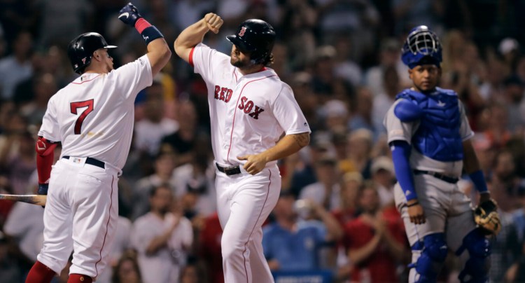 Sam Travis, right, celebrates with Christian Vazquez after hitting a two-run home run in the third inning of Boston’s 7-5 win over the Kansas City Royals on Monday at Fenway Park.