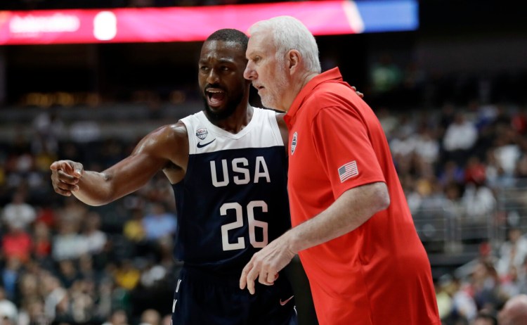 Kemba Walker, left, talks to  Coach Gregg Popovich during the first half of Team USA's 90-81 win over Spain in an exhibition game Friday in Anaheim, California.