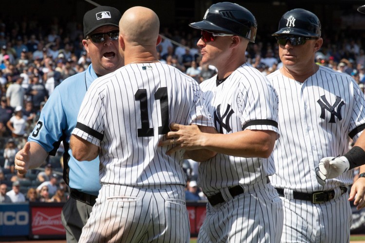 Brett Gardner, 11, argues with third base umpire Todd Tichenor after being ejected in the sixth inning of the Yankees' 6-5 win over the Cleveland Indians on Saturday in New York. Pitcher CC Sabathia and Manager Aaron Boone were also ejected.