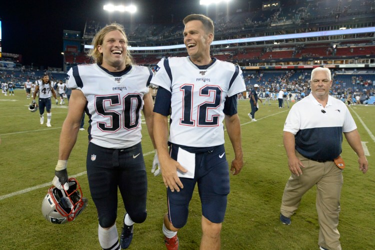 Tom Brady, right, did not play in the Patriots' 22-17 win over the Titans on Saturday, but rookie defensive lineman Chase Winovich did and he continues to be impressive. 
