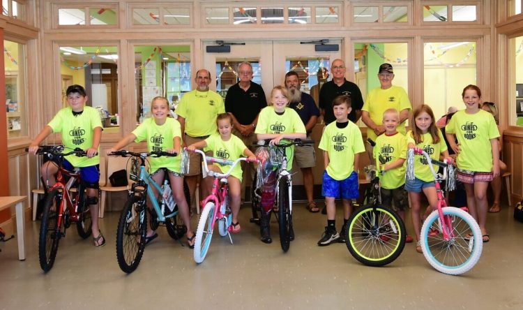 Bikes for Books winners front from left are Thomas Gamage, Makayla Peaslee, Natalie Peaslee, Morghana Taheny, Ethan Nichols, Brycen Miller, Madelyn Gagnon and Kelsie Huard. Masons from left are Jason Carey, Richard Kimball, Keith Dirago, Robert Stratton and Bud Pringle.