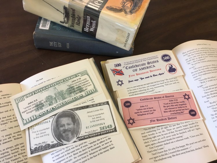 Dozens of inserts made to look like counterfeit bills were found in multiple books from the Curtis Memorial Library in Brunswick.