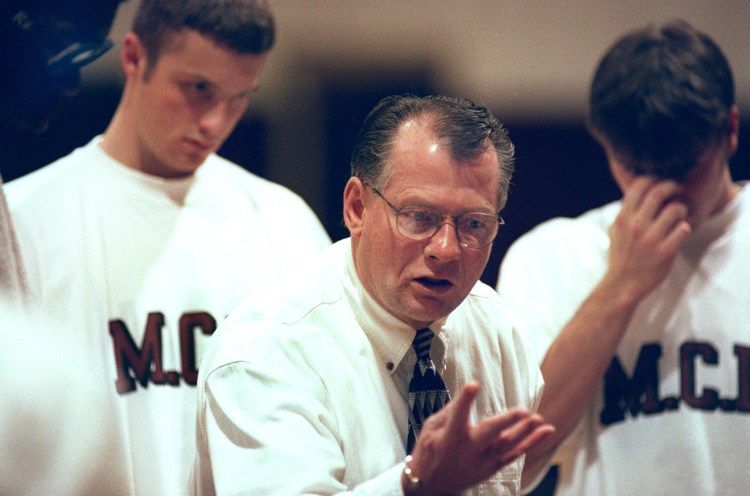 Maine Central Institute prep coach Max Good talks to his team during a timeout of a Jan. 14, 1999 game against Milton Academy.