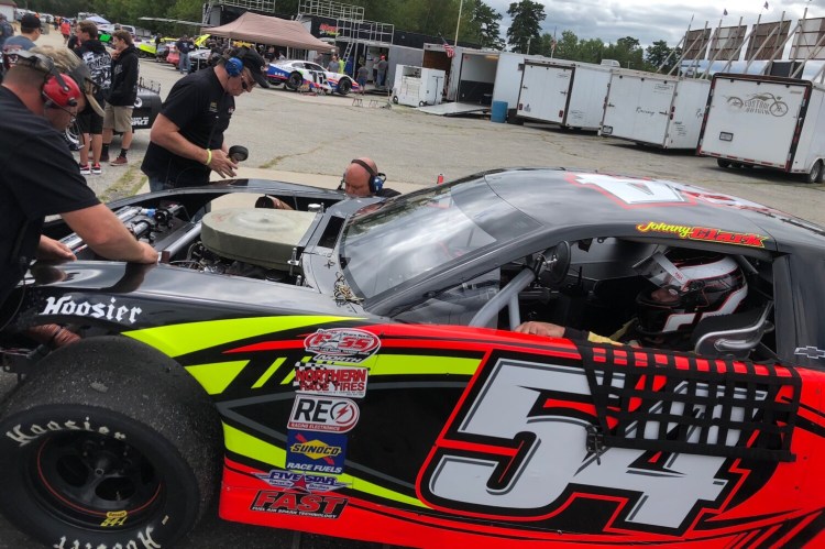 The crew for six-time Pro All Stars Series champion Johnny Clark goes to work on his No. 54 during a practice session Saturday for the 46th annual Oxford 250 at Oxford Plains Speedway in Oxford.