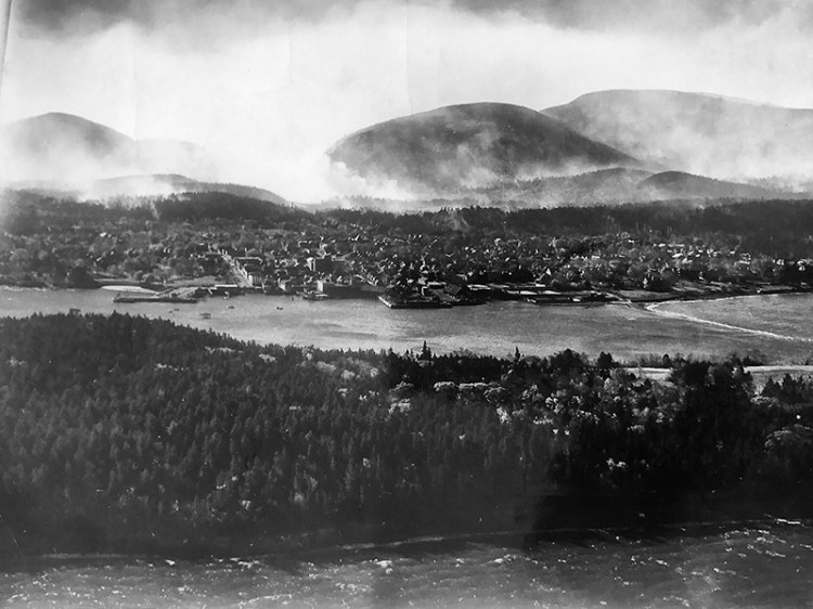 Bar Harbor with the mountains of Acadia behind it, after fire passed through in 1947.