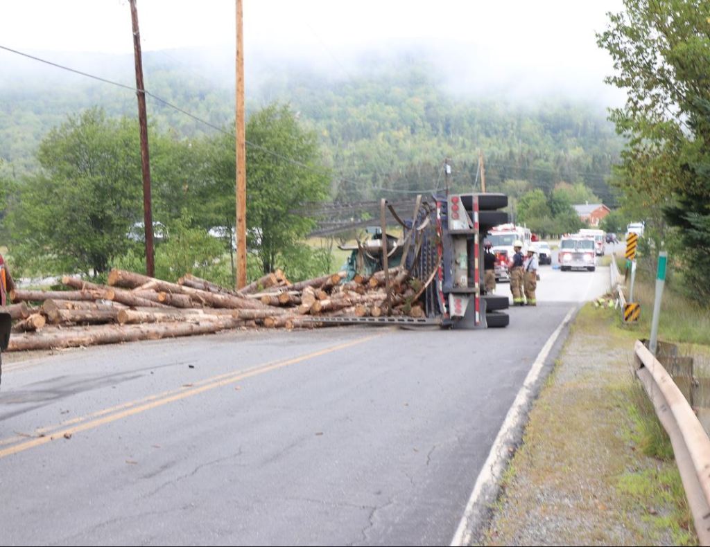 A logging truck rolled over Wednesday morning on Route 16 in northern Oxford County, seriously injuring the driver from Vermont. 