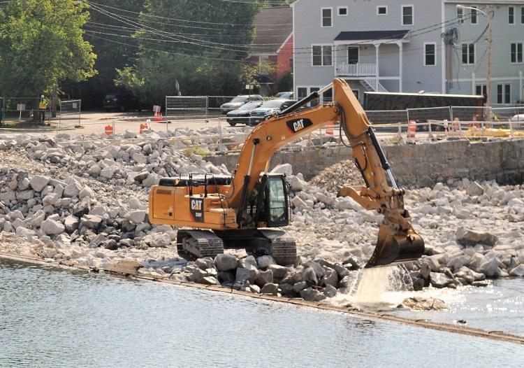 Work is performed on Wednesday on the Springs Dam in Saco. 