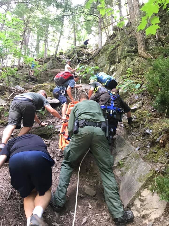 Deputy Brian Crater of the Somerset County Sheriff's Office and responders help rescue a 10-year-old boy who fell 20-30 feet Saturday onto rocks off a hiking trail at Moxie Falls. 