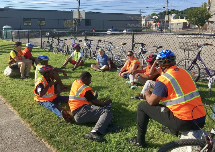 The Bikes for All Mainers class gets ready to ride July 18 at Kennedy Park in Portland. The program, which has a special outreach to new Mainers, teaches bike safety and responsibility, and allows participants to earn a bike at the end of the course.