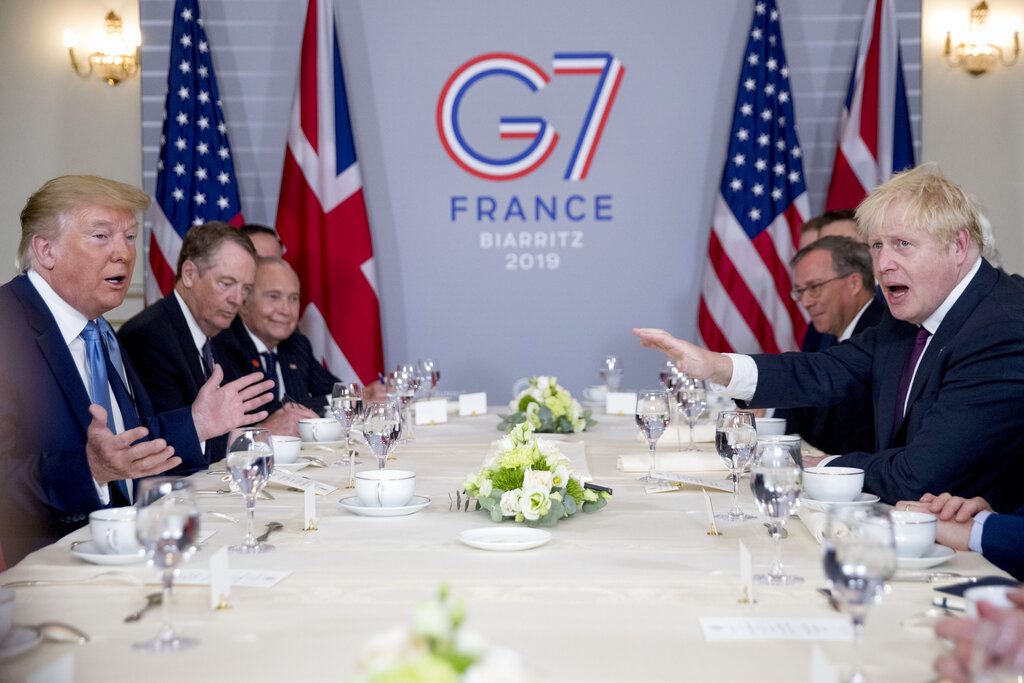 President Trump and Britain's Prime Minister Boris Johnson, right, attend a working breakfast at the Hotel du Palais on the sidelines of the G-7 summit in Biarritz, France, Sunday. 