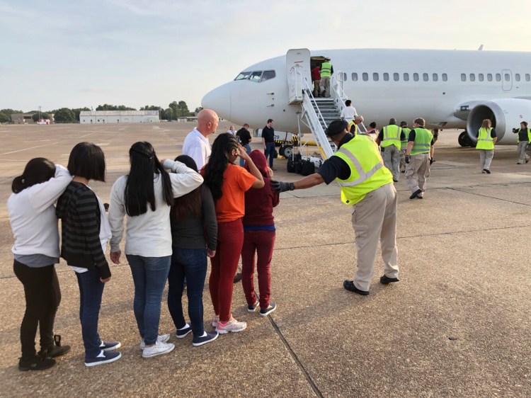 Deportees at an airfield in Alexandria, Louisiana, line up to board an ICE Air flight to Guatemala. 