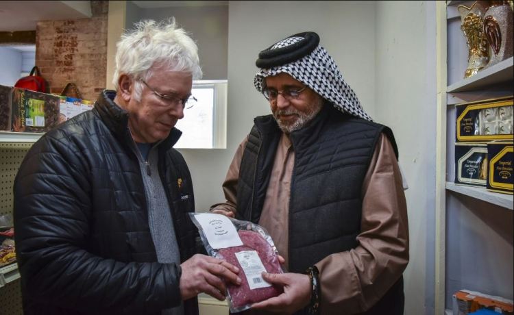Central Maine Meats co-owner Joel Davis, left, discusses distribution of halal-certified meat with Khalid Zamat, owner of a newly opened Iraqi grocery store in Hallowell, in 2017.