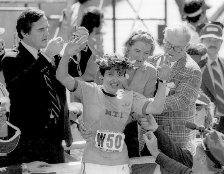 Rosie Ruiz waves to the crowd after receiving the laurel wreath. Ruiz pretended to win the 1980 Boston Marathon by coming out of the crowd about one mile before the finish line.  