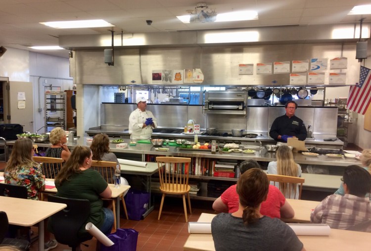 Mike Flynn, left,  director of student nutrition services RSU 12 and Patrick Britten, Sysco of Maine corporate chef, during the training for 80 regional school nutrition staff on Aug. 15 at Mt. Blue High School in Farmington.
