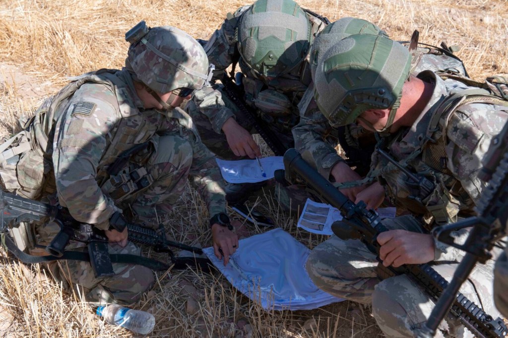 U.S. and Turkish military forces go over a map in preparation for their second joint ground patrol inside the so-called "safe zone" in northeast Syria near the border with Turkey. 
